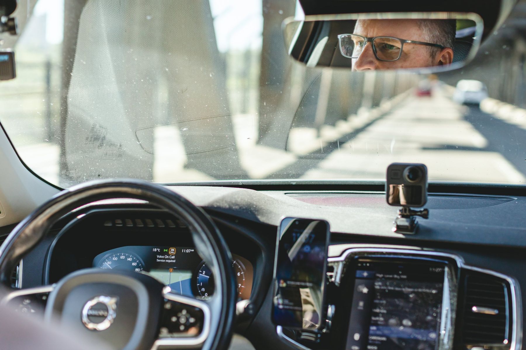 Brad driving, seen in the rear-view mirror