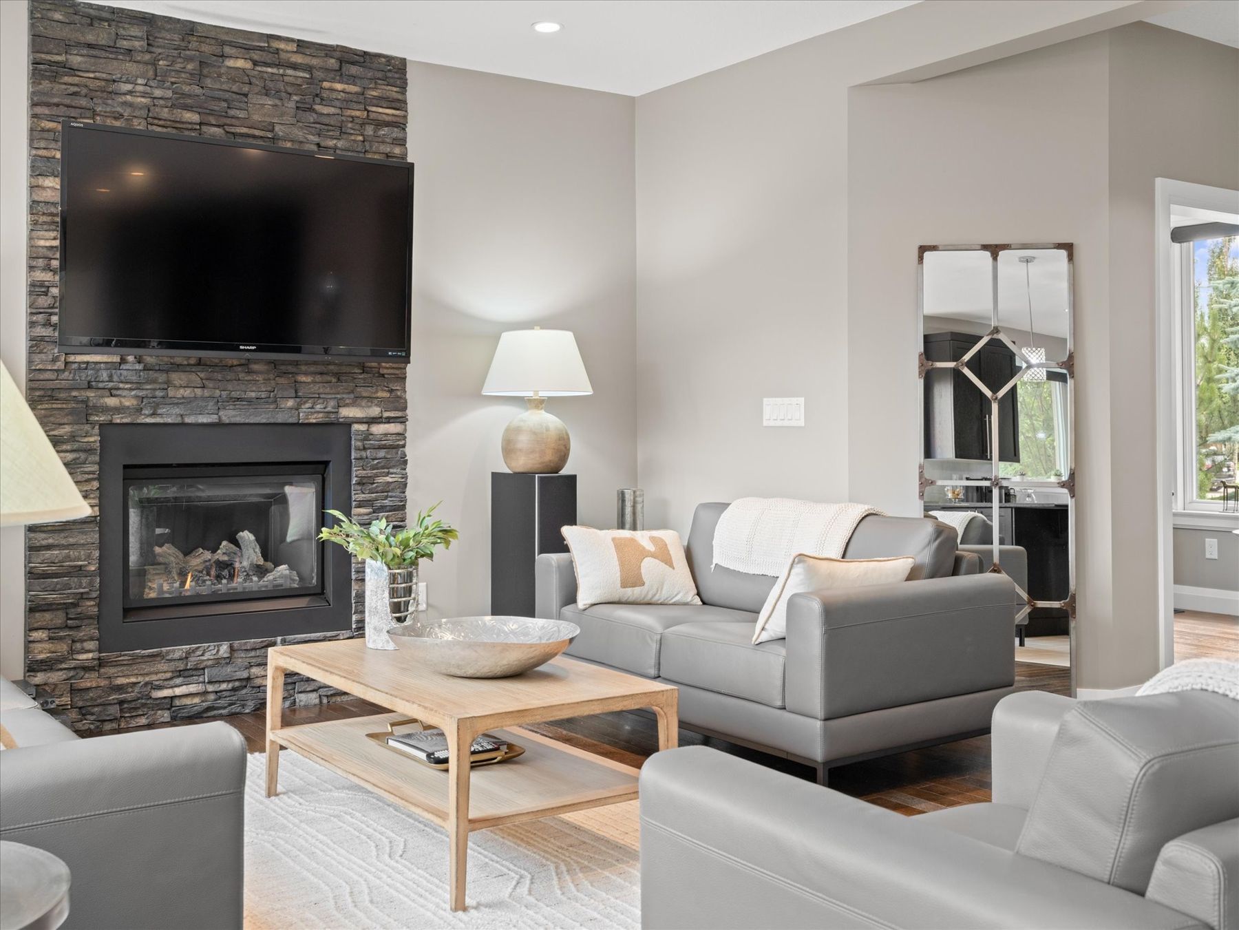 A bright living room with a stone fireplace